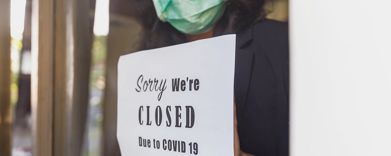 fermeture de boutique et femme avec masque