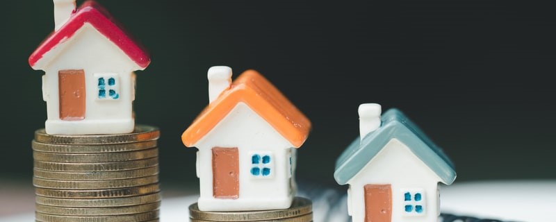 modèles de maison sur piles de pièces